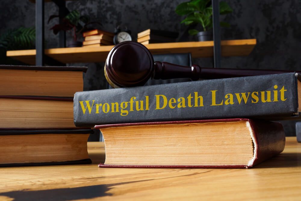 A wooden gavel rests atop a black book titled
