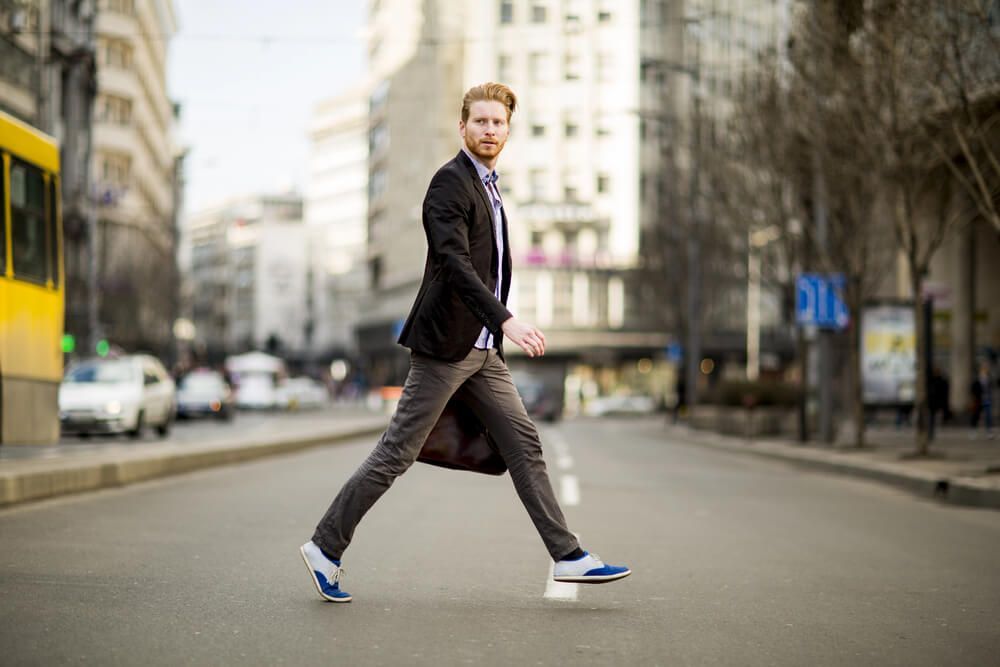 A man in a suit and tie is walking down the street.