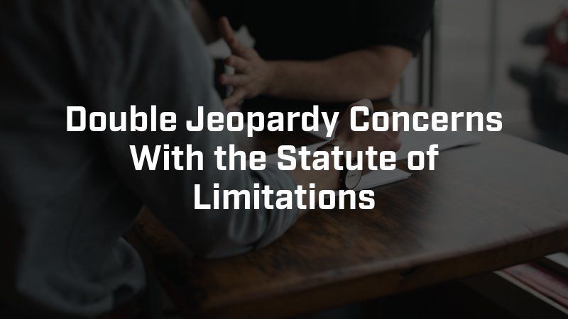 Text overlaid on a dimly lit scene of two people seated at a wooden desk with paper: