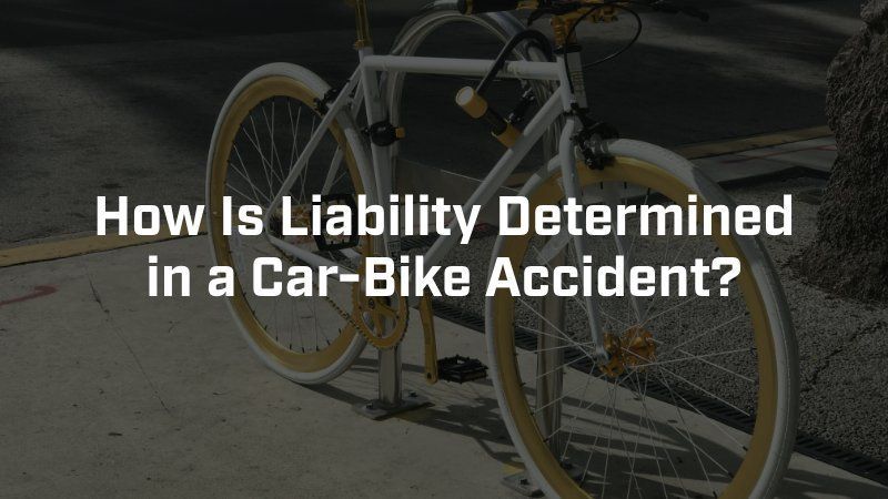 A bicycle is chained to a pole on the side of the road.