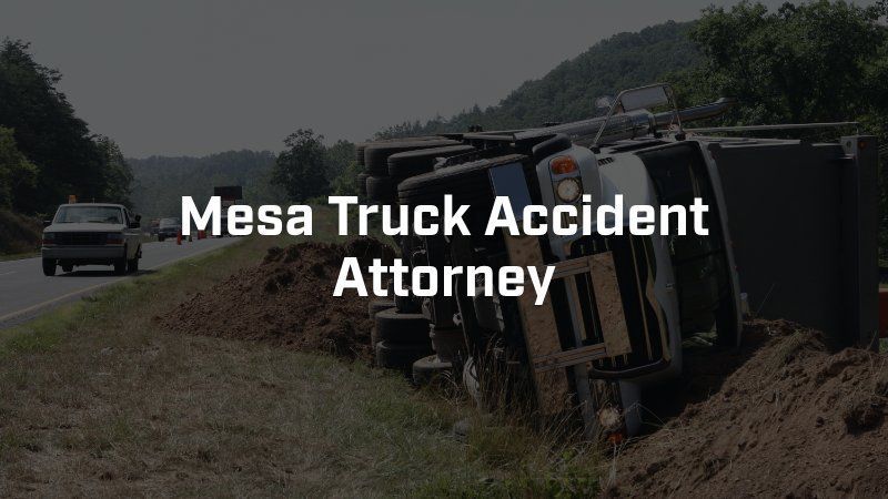 A truck has turned over on the side of the road.