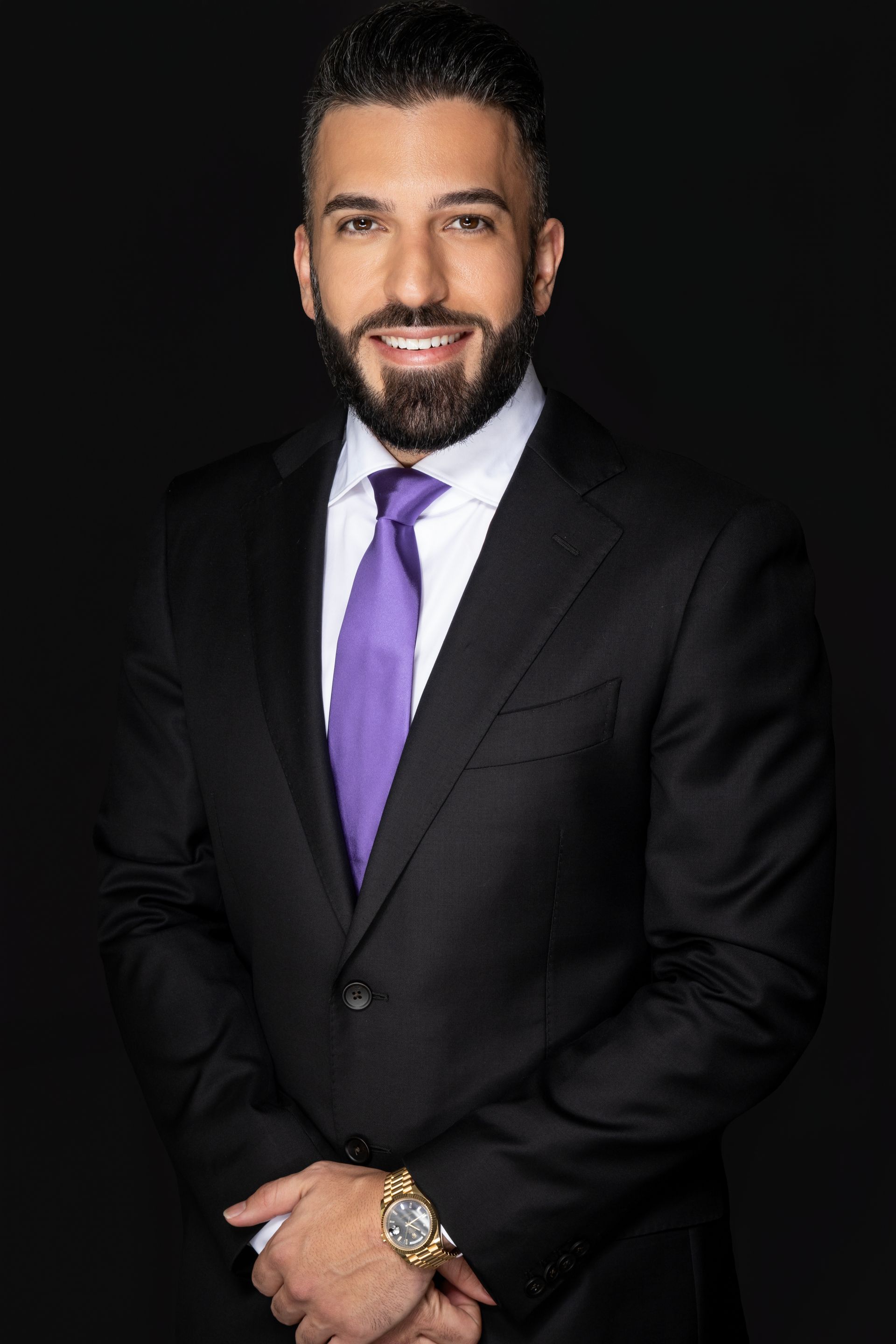 A man with a beard wearing a suit and tie