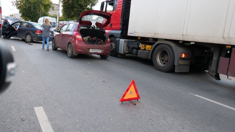 A truck has crashed into a car on the road