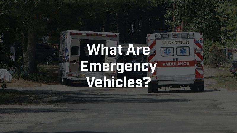 Two ambulances are parked on the side of the road.