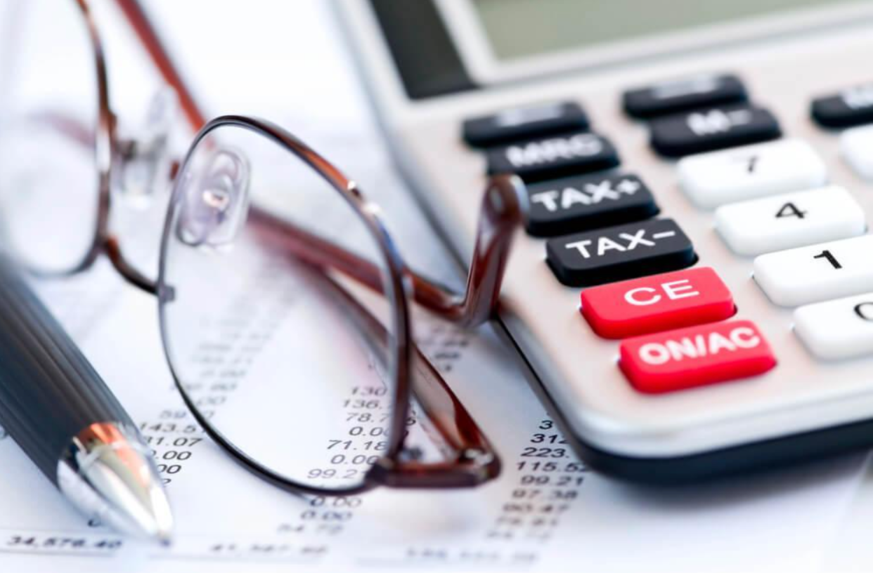 A pair of glasses sitting on top of a calculator