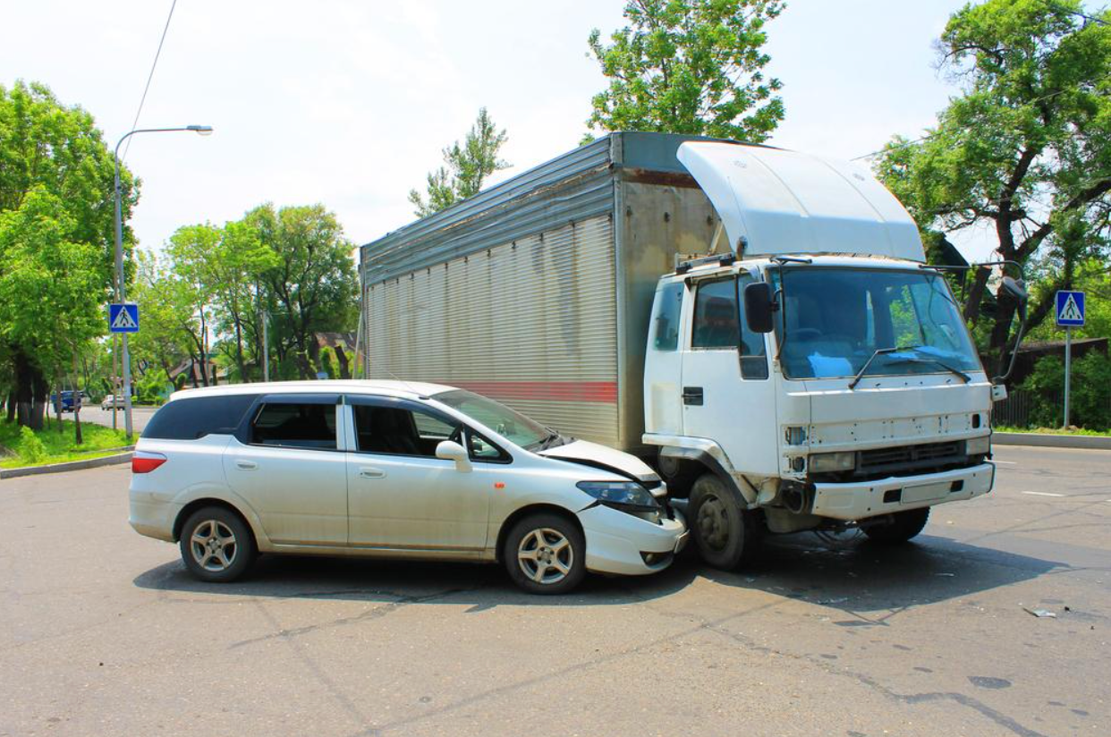 A truck and a car are involved in a traffic accident.