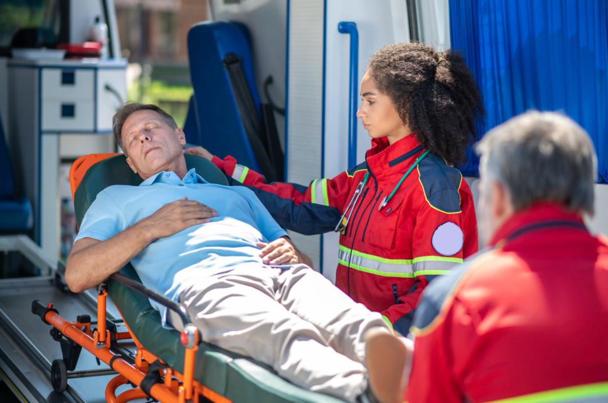 A man is laying on a stretcher in an ambulance.