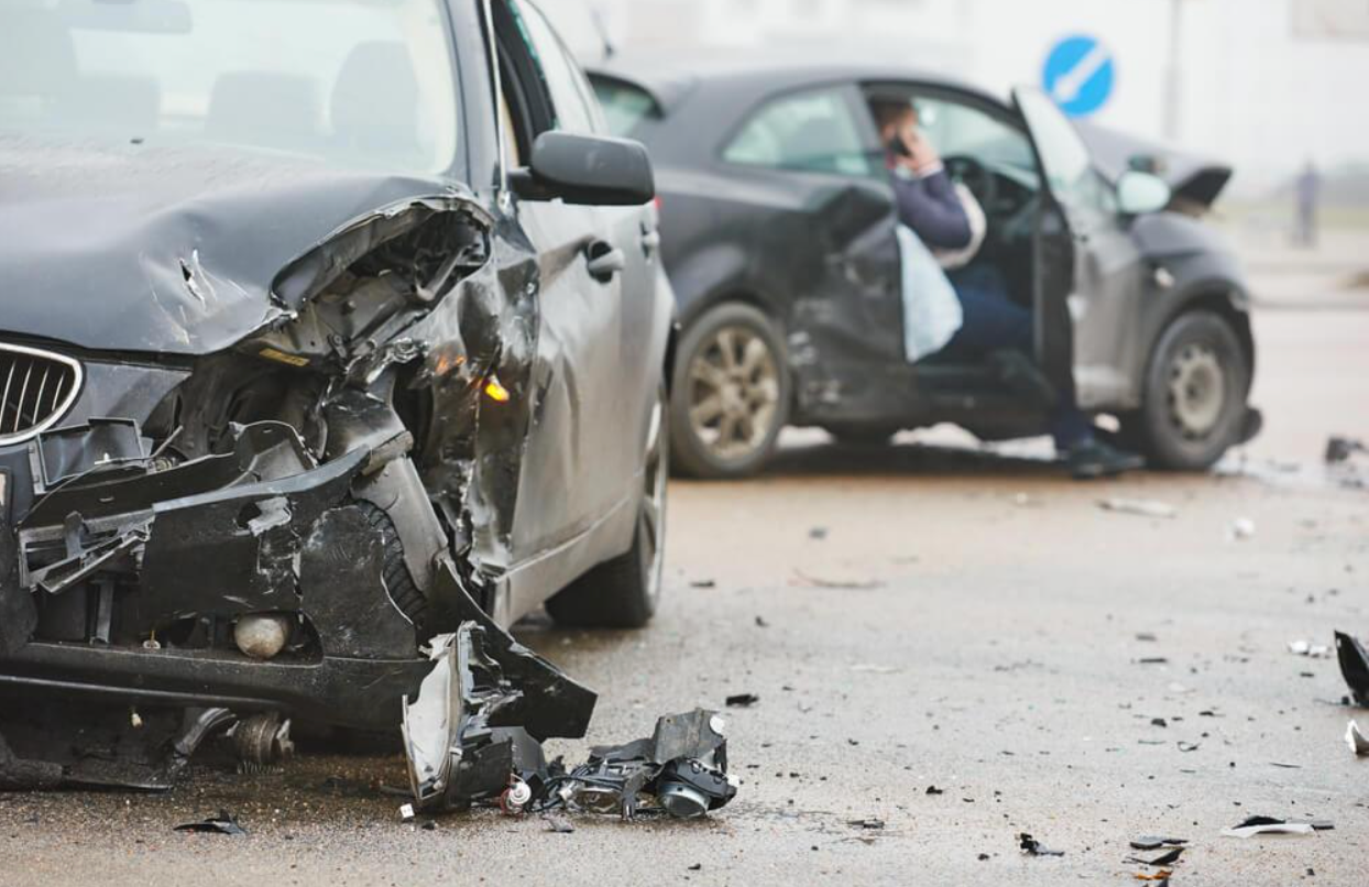 Two cars are involved in a car accident on a city street.