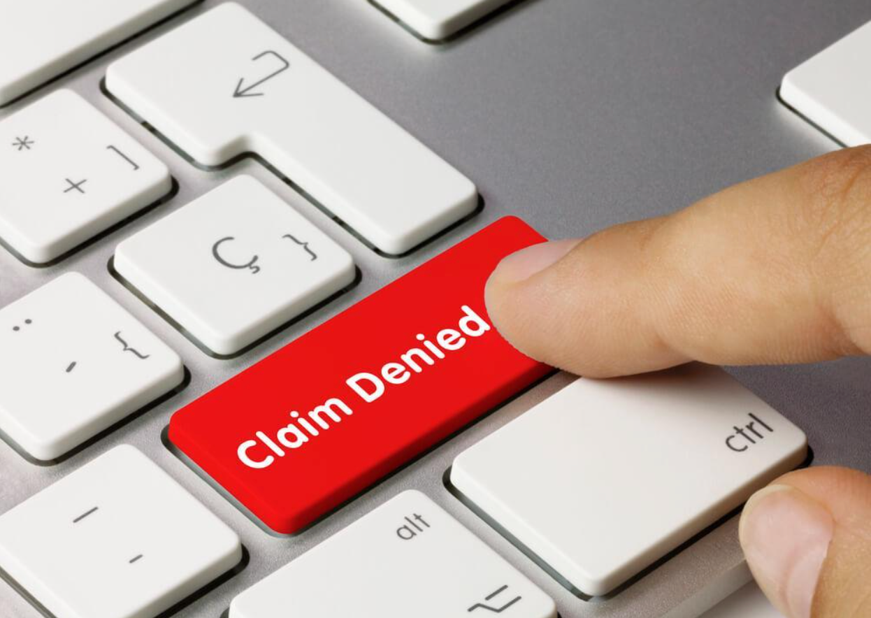 A person is pressing the claim denied button on a keyboard