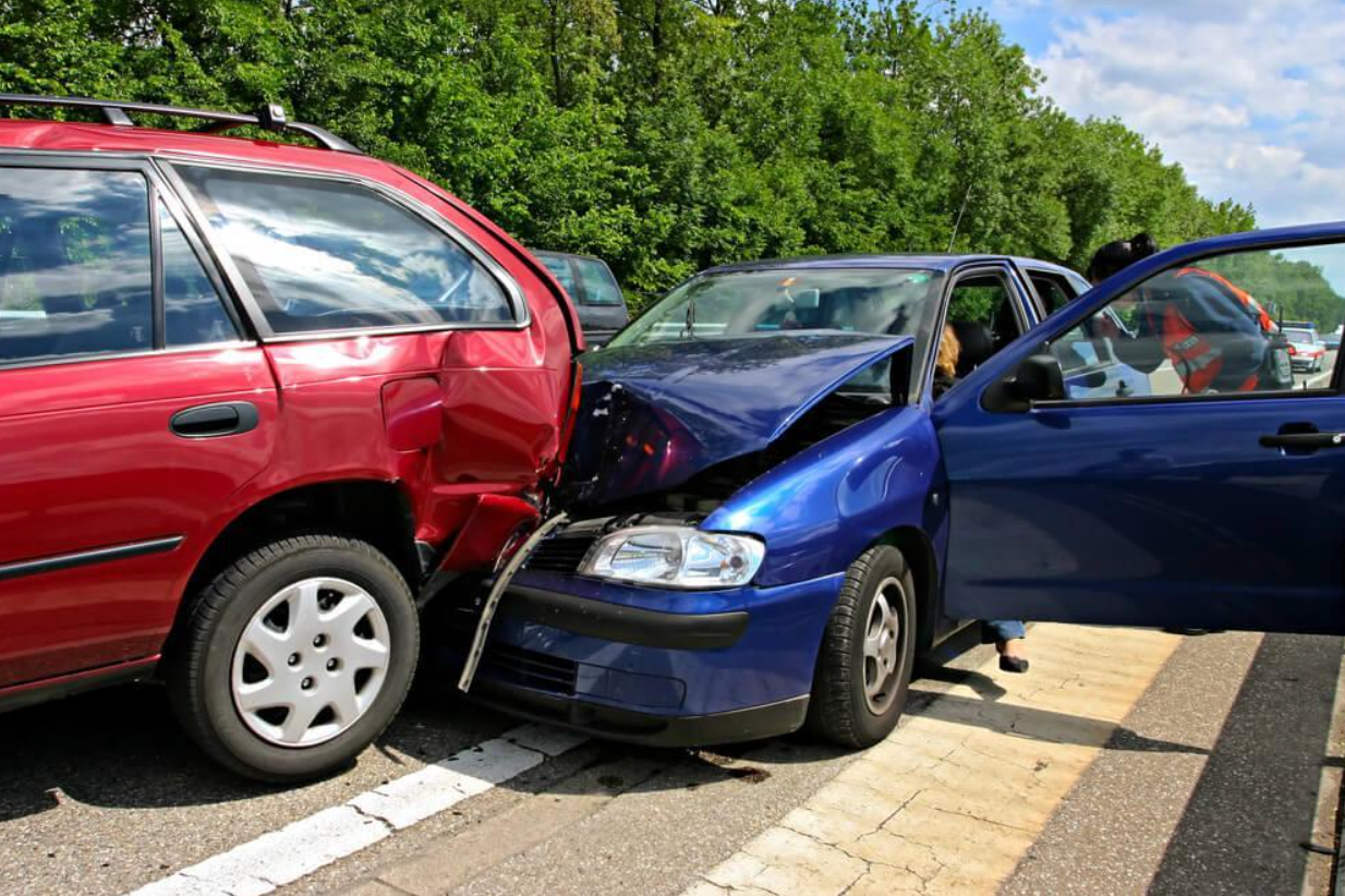 A red car and a blue car are involved in a car accident.