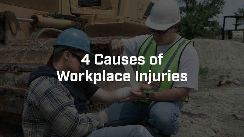 A worker bandages another's arm at a construction site, with the text