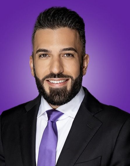 A man with a beard wearing a suit and tie