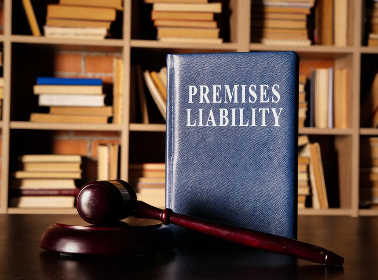 A book titled premises liability is on a table next to a wooden gavel.