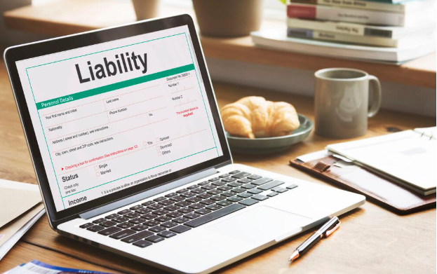 A laptop computer is open to a page with the word liability on it.
