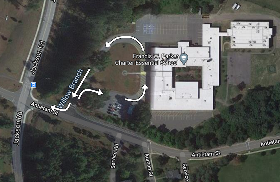 Aerial view of Francis M. Yorke School with white arrows indicating the traffic flow loop for vehicle drop-offs.