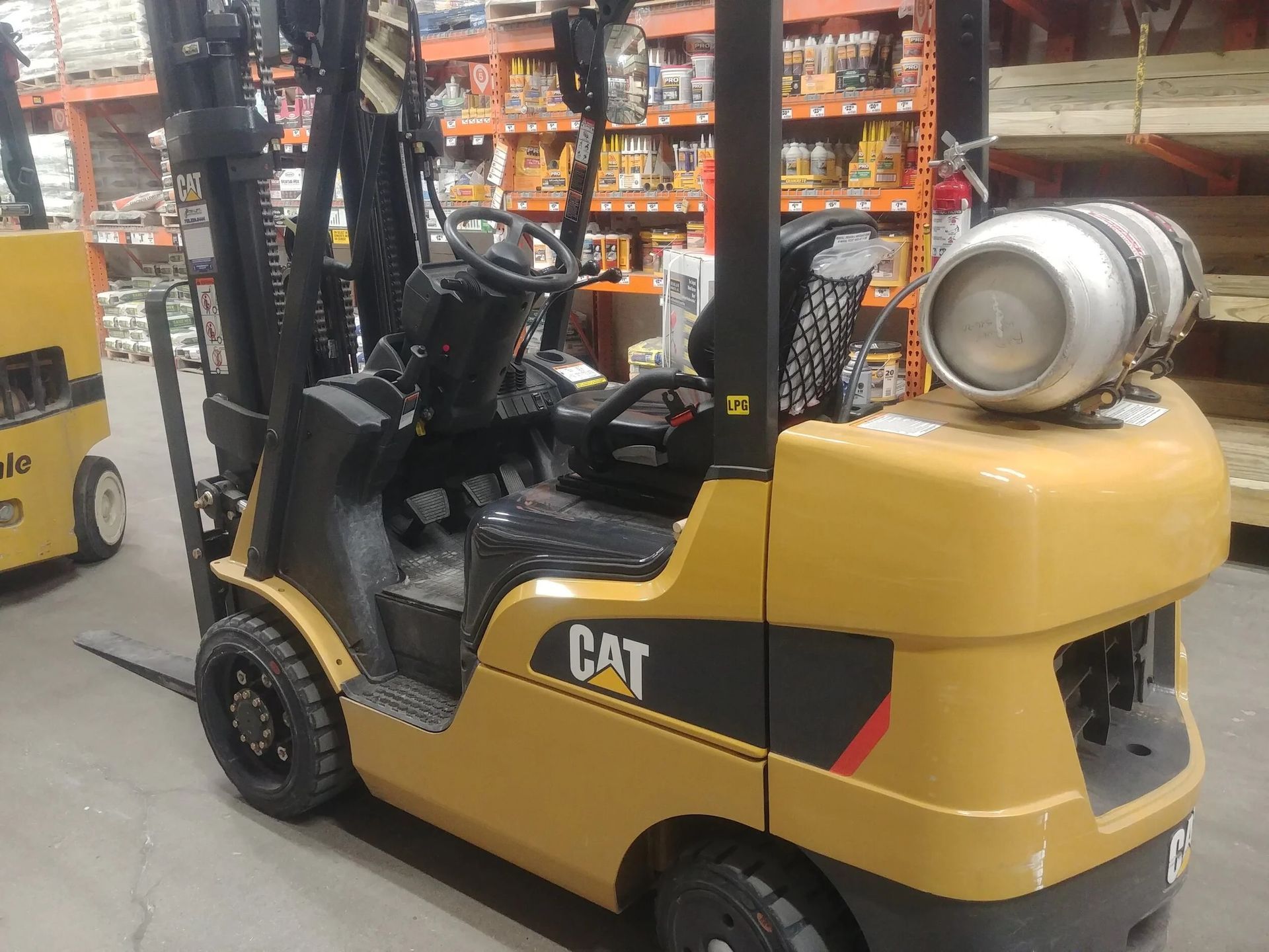 Yellow Caterpillar forklift inside a warehouse.