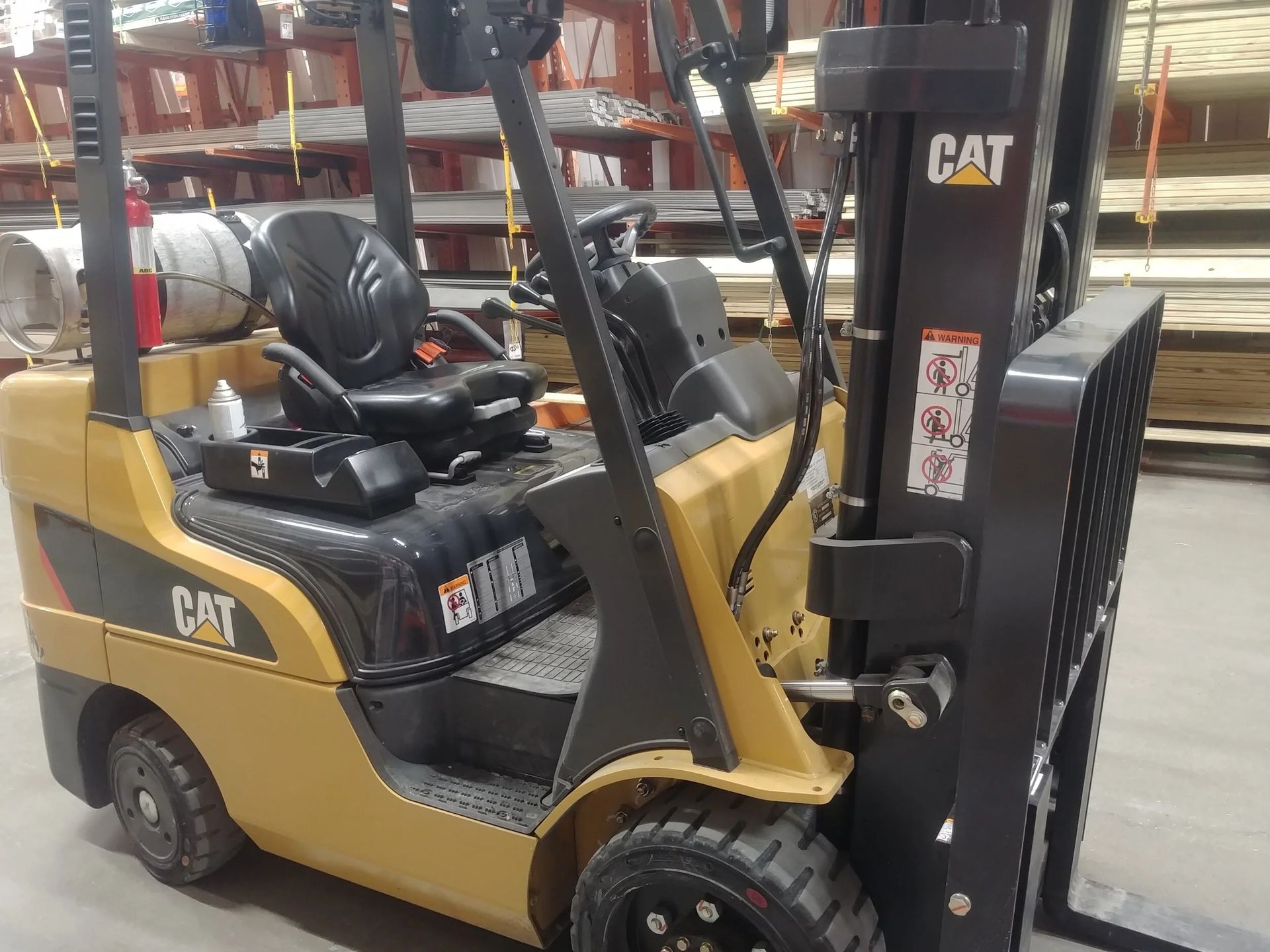 Yellow Caterpillar forklift in a warehouse.