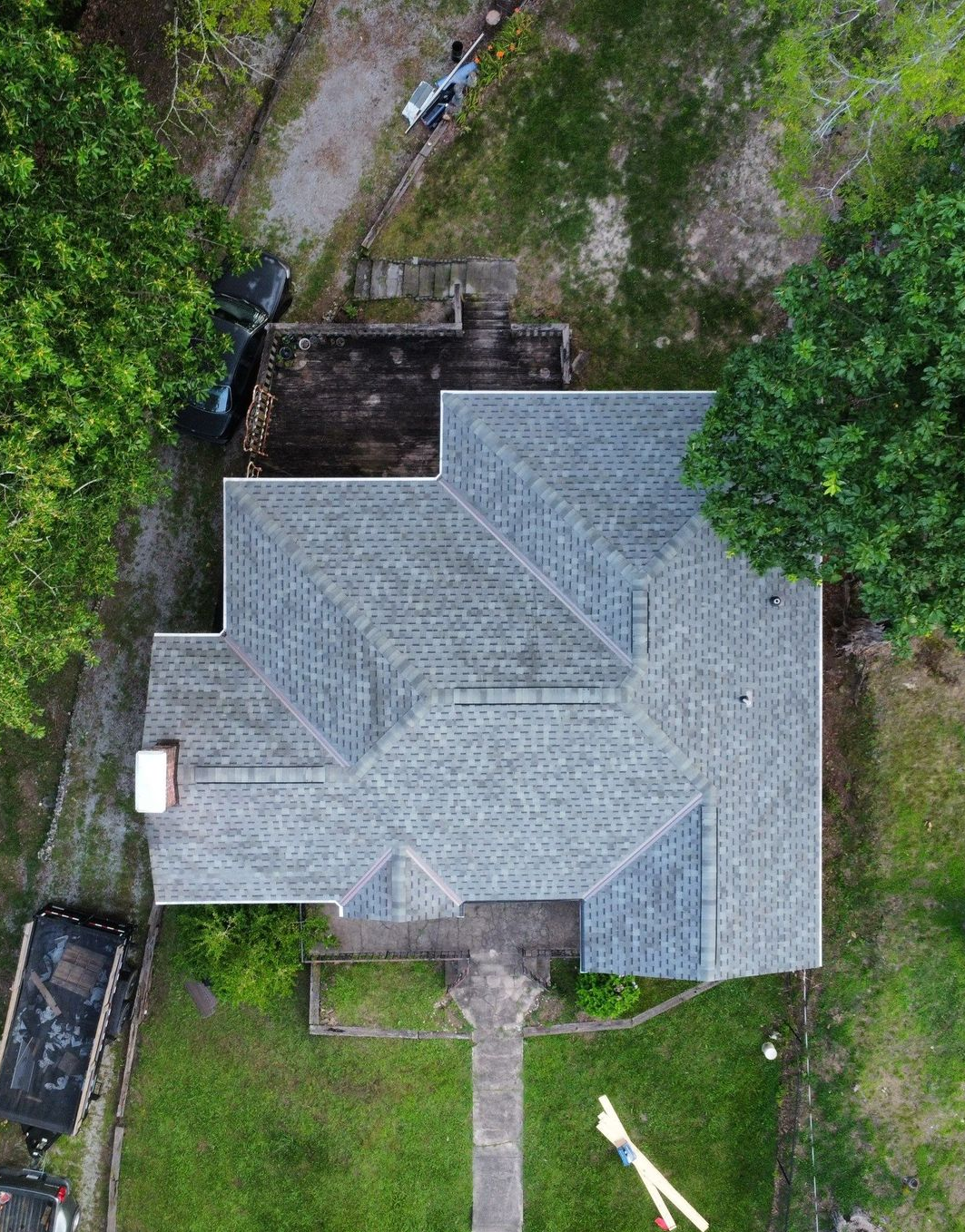 A single-story, light yellow house with a brick-covered lower exterior and a