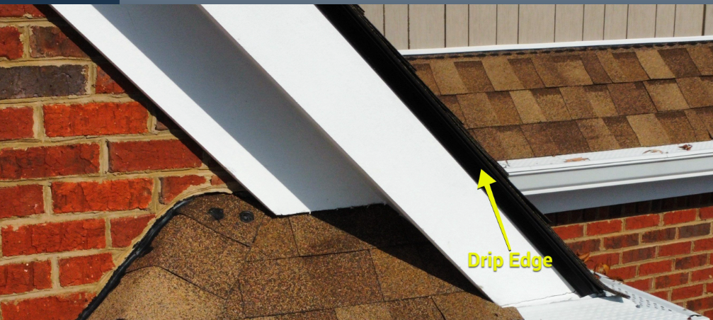 A yellow arrow points to the black drip edge installed along the rake of a roof next to a brick wall.
