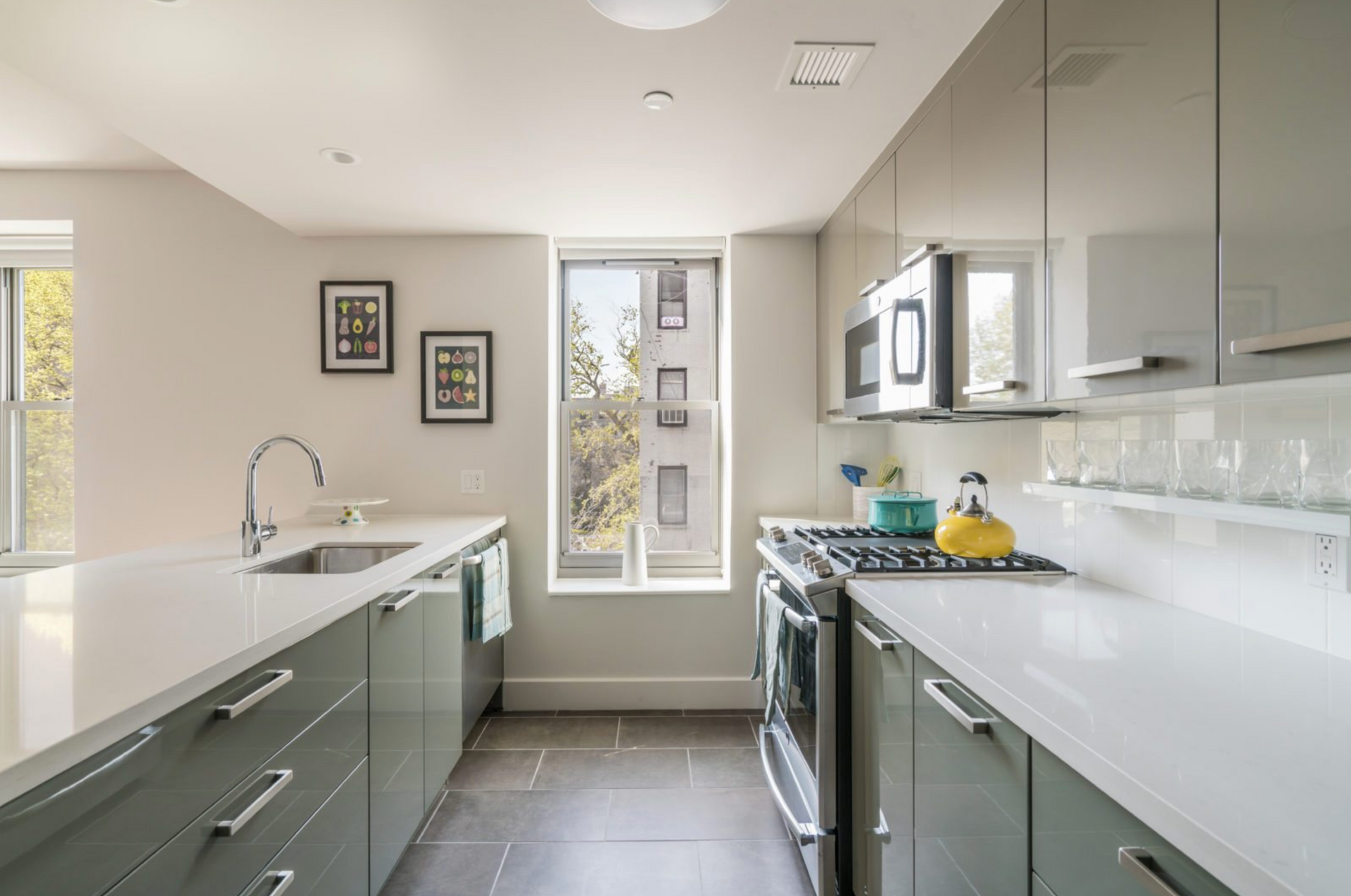 a kitchen with a stove , sink , and microwave