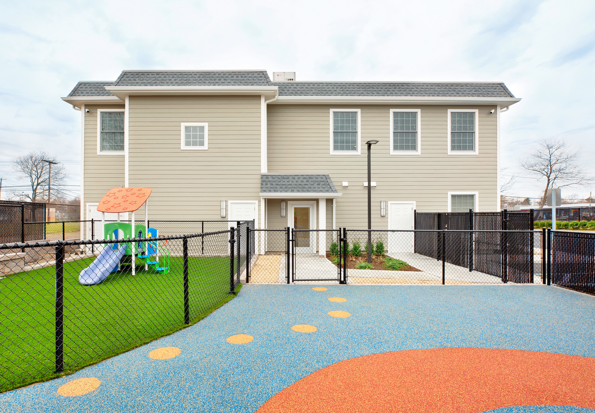 a large house with a playground in front of it .