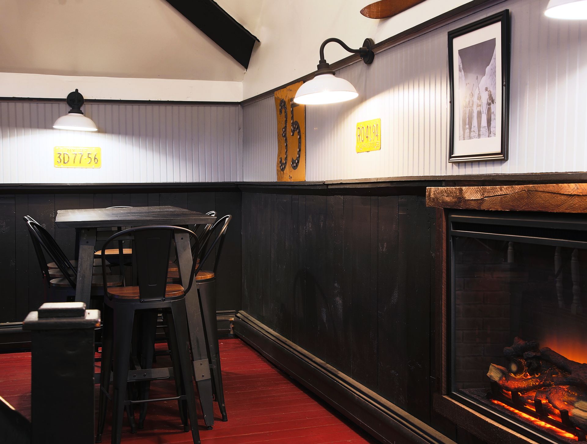 A room with a table and chairs and a fireplace