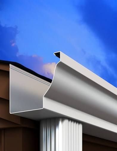 Close-up of a white metal gutter and downspout against a blue sky