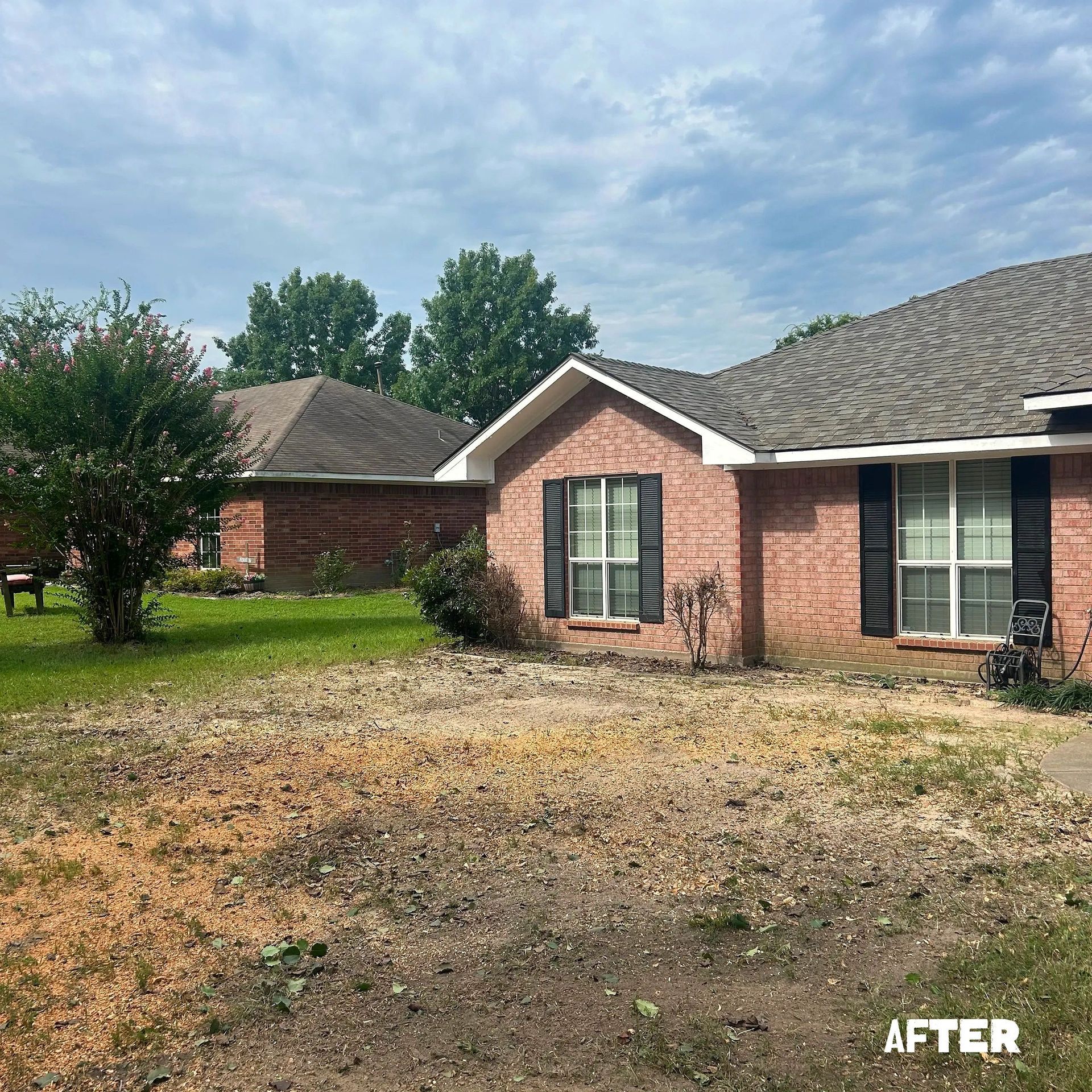 Brick house exterior with patchy, dry lawn; 