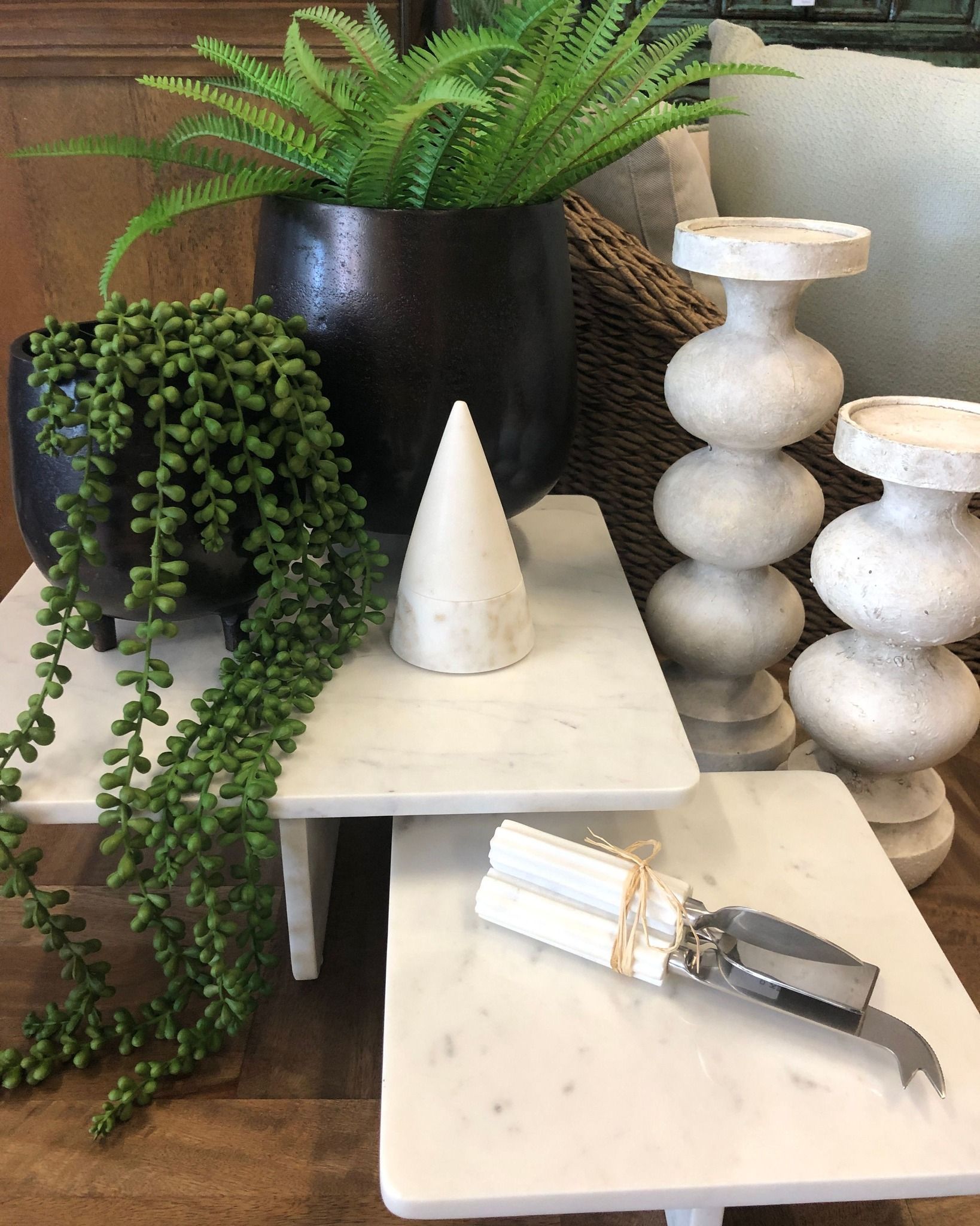 Decorative White Cones And Candlesticks On Display With A Black Planter And Trailing Green Plant — Tropic Living in Kewarra Beach, QLD