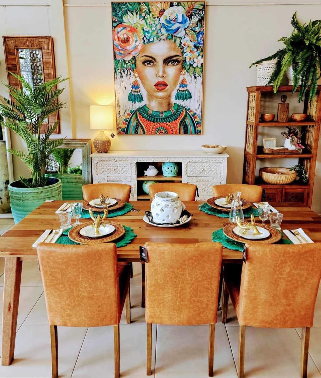 Stylish Dining Room With a Set Table, Tan Chairs, Plant Decor, and a Colorful Portrait Above a Sideboard — Tropic Living in Clifton Beach, QLD