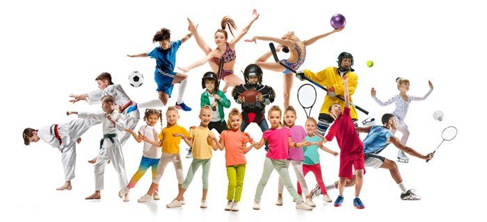Group of children and teens in colorful clothes jumping and playing sports with balls and rackets on white background