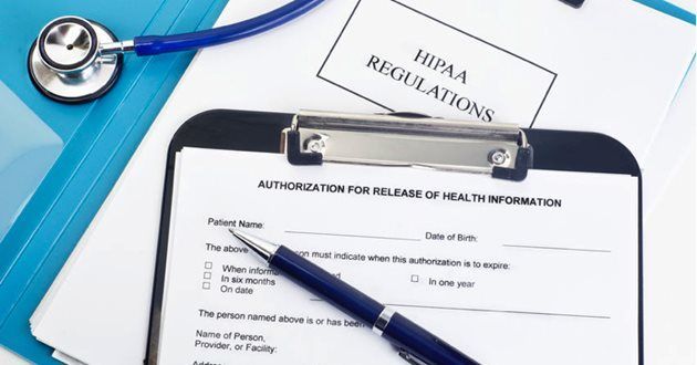 Clipboard with health information release form, pen, stethoscope, and HIPAA regulations document on a desk