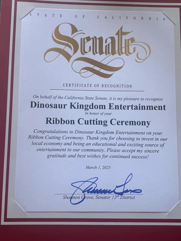 California Senate certificate recognizing Ribbon Cutting Ceremony at Dinosaur Kingdom Entertainment, with blue signature