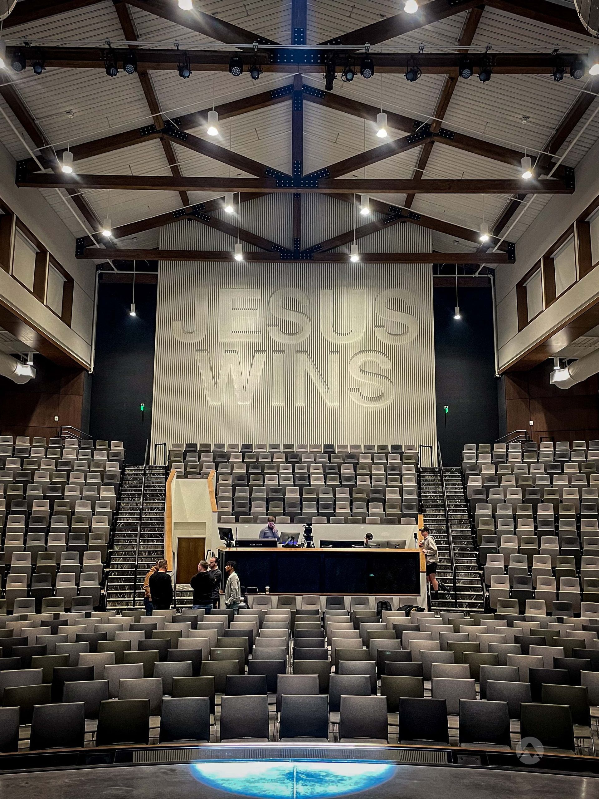 A large auditorium with a large clock on the wall