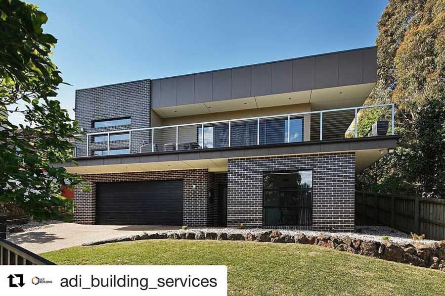 A Large Brick House with a Black Garage Door | Warragul, VIC | ADI Building Services