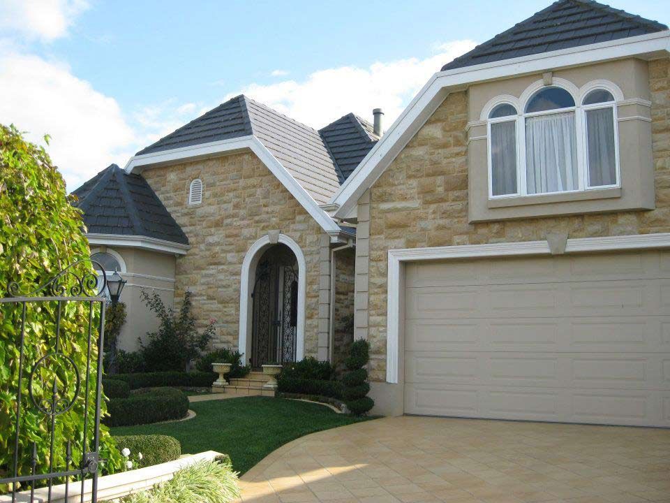 A House with a White Garage Door and Arched Windows | Warragul, VIC | ADI Building Services