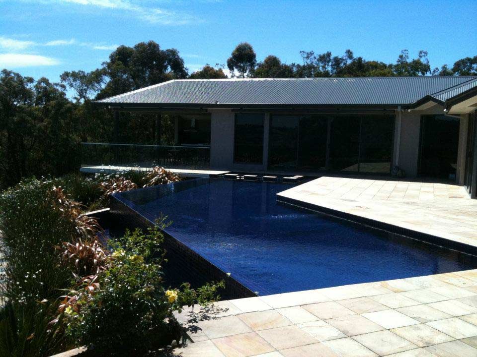 A Large House with a Large Swimming Pool in Front of It | Warragul, VIC | ADI Building Services