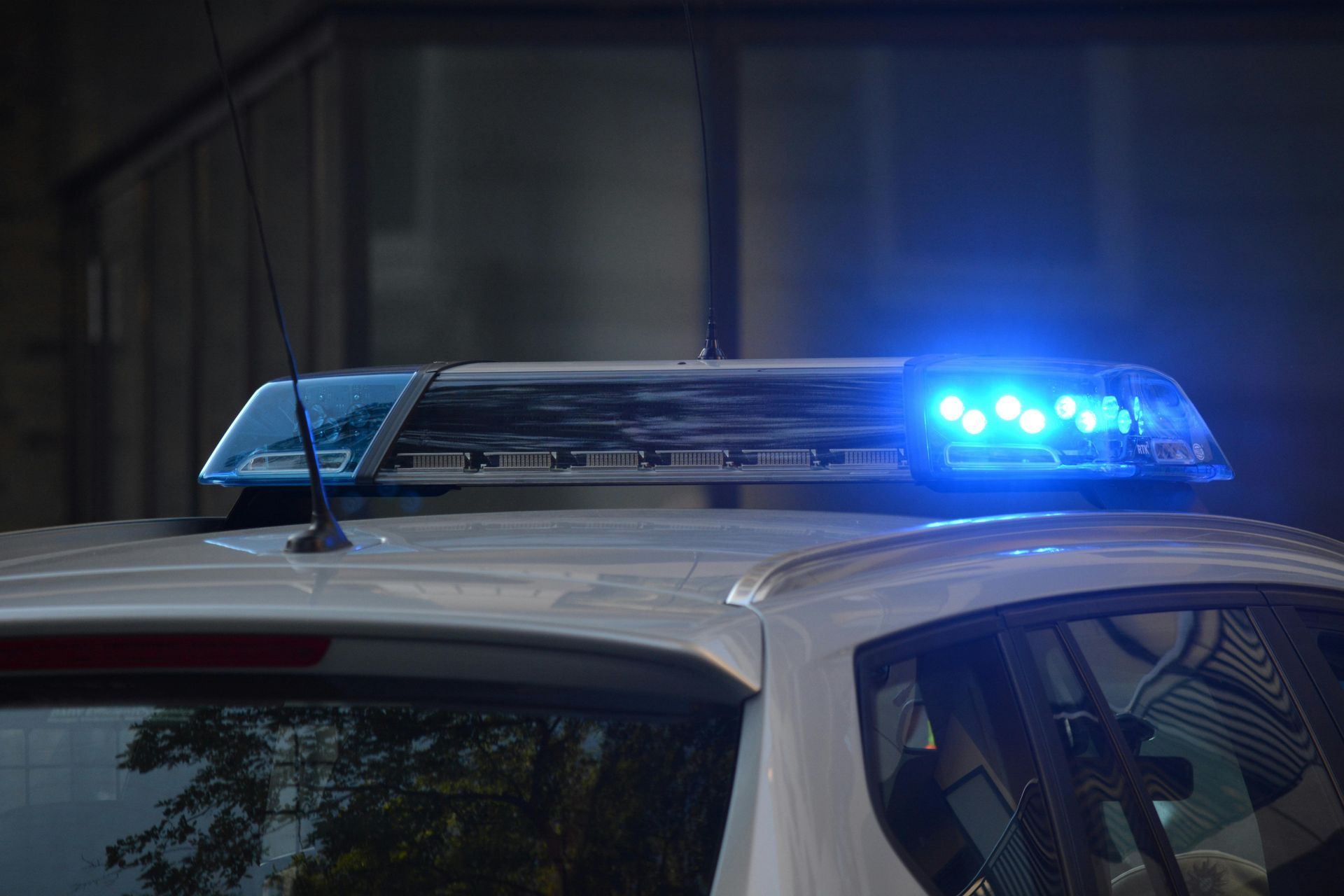 Police car with flashing blue lights.