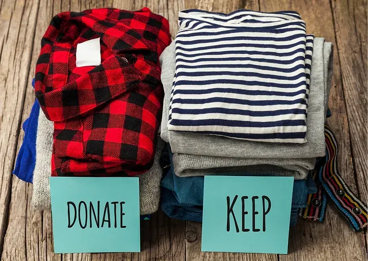 Piles of folded clothes sorted into