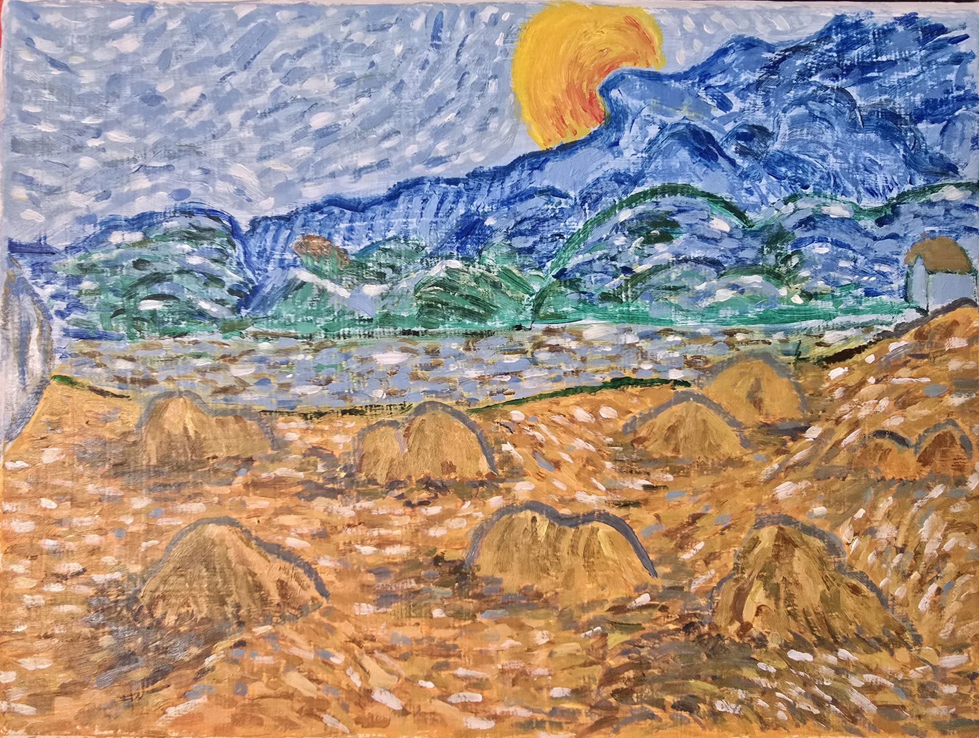 Sunlit mountain landscape with blue hills, green valley, and golden fields under a cloudy sky