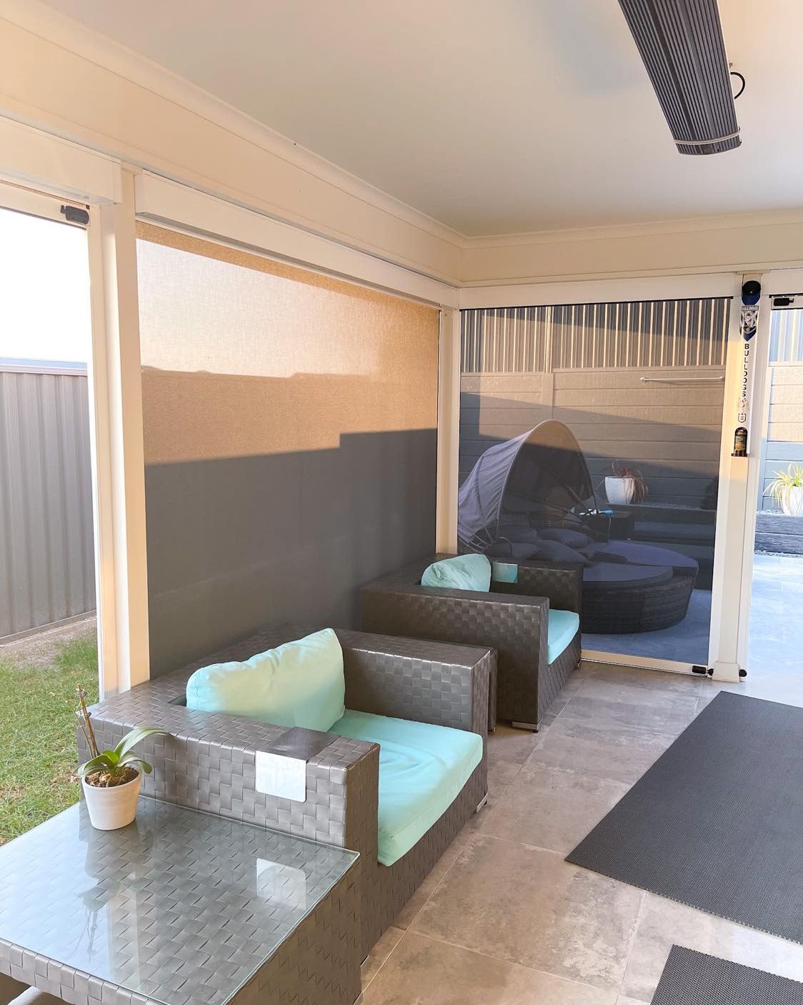 A patio with chairs , a table and a potted plant. — Phoenix Blinds In Albion Park Rail, NSW