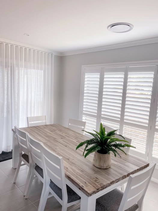 There Is a Plant on The Table in The Dining Room — Phoenix Blinds In Shellharbour, NSW