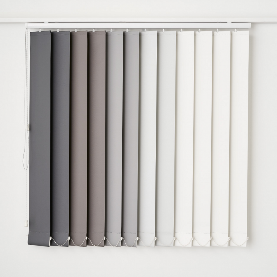 A Vertical Blind Is Hanging on A White Wall — Phoenix Blinds In Albion Park Rail, NSW