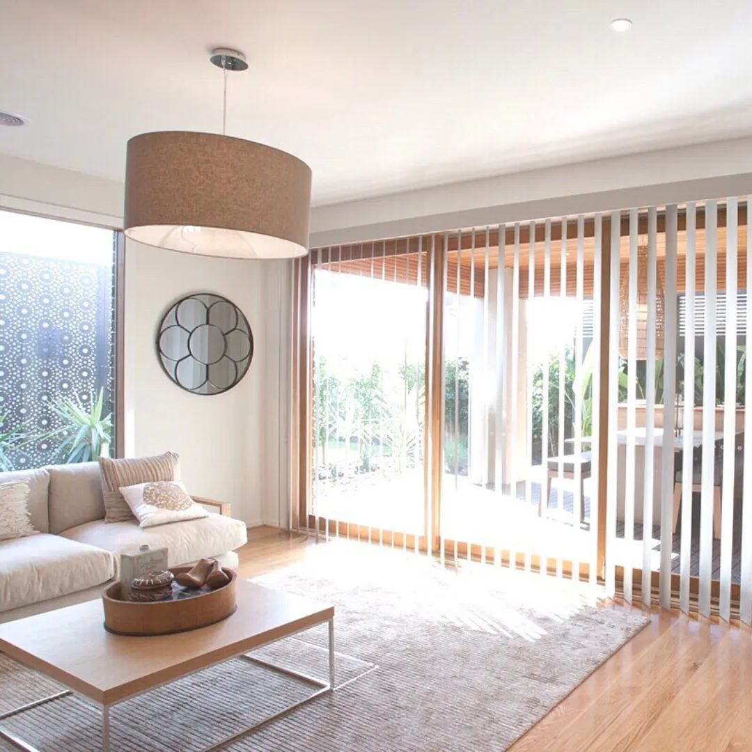 A Living Room with A Couch and A Coffee Table — Phoenix Blinds In Albion Park Rail, NSW