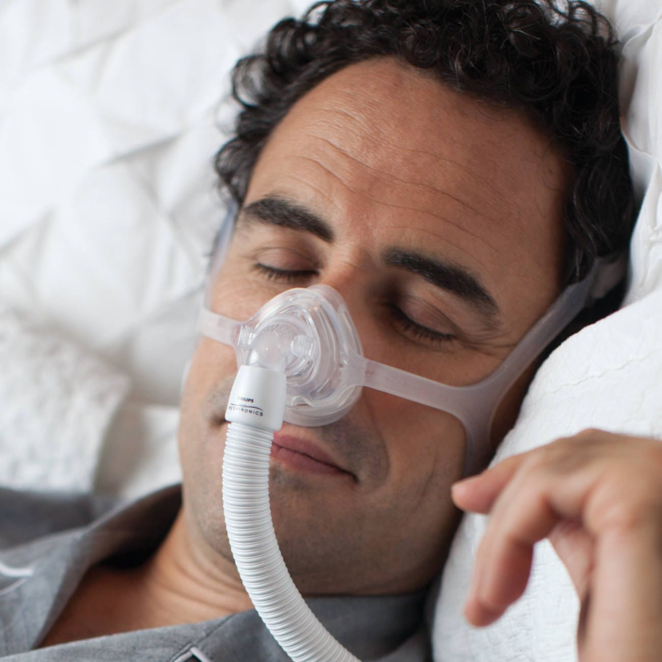 A man is wearing a cpap mask on his face.