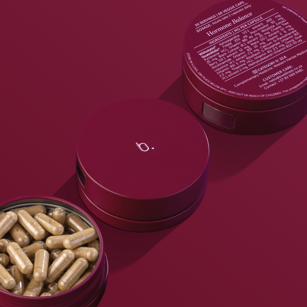 Deep red containers, one open displaying tan capsules and another closed with a 