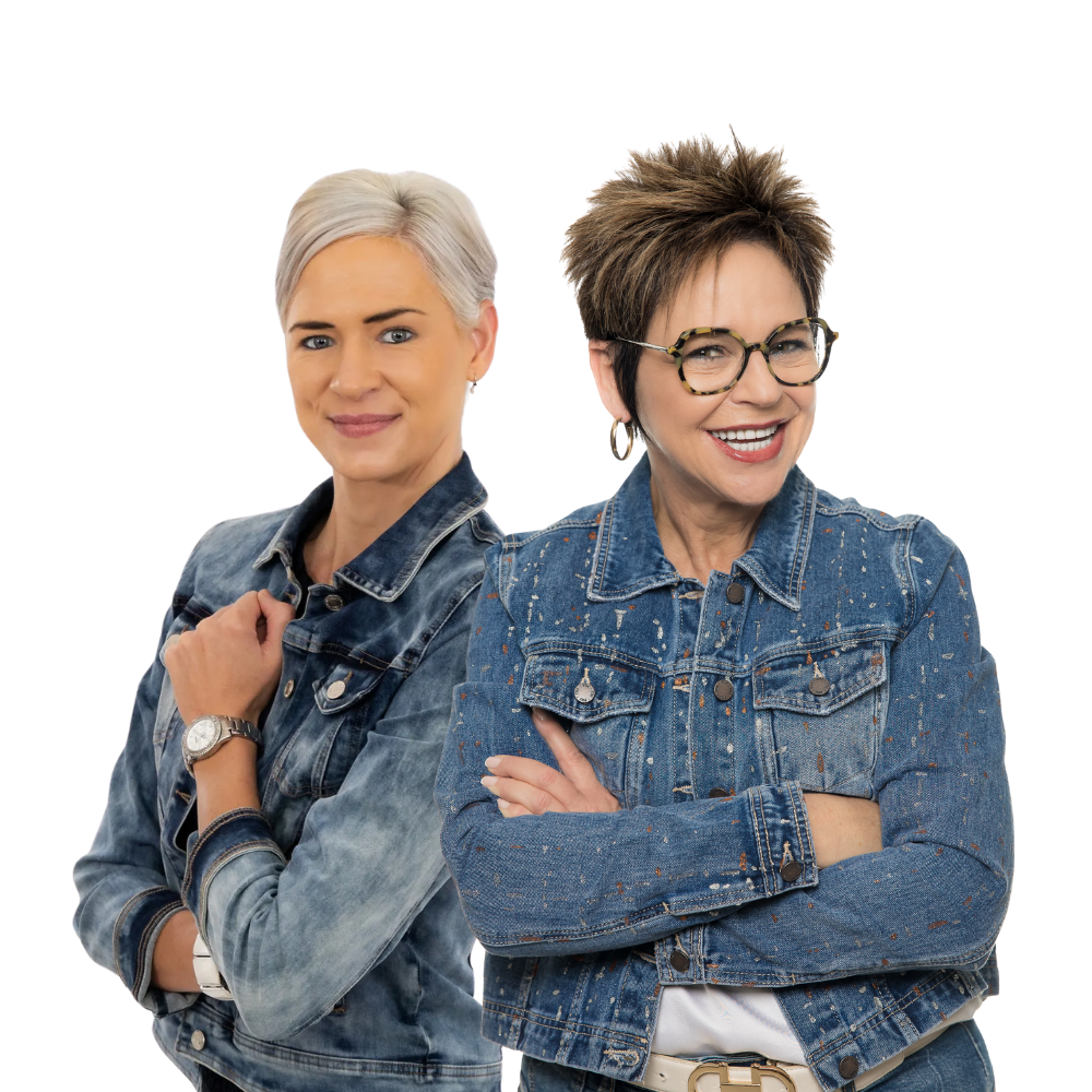 Two people wearing matching denim jackets pose together against a plain white background.