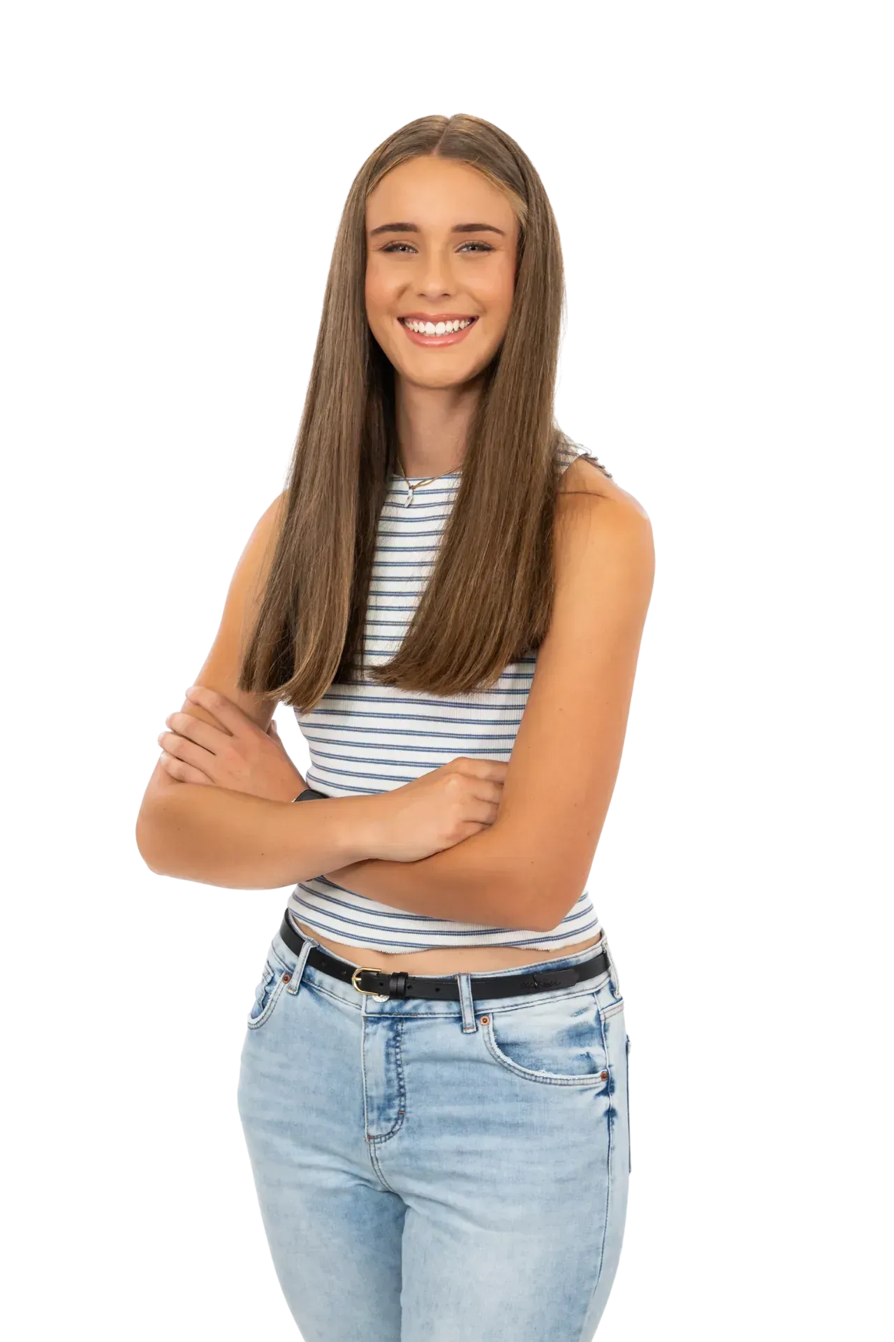 A person with long brown hair, wearing a striped sleeveless top and light-wash jeans, smiling with arms crossed.