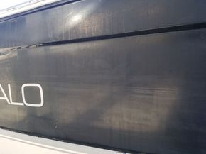 A close up of the side of a boat with the word alo written on it.