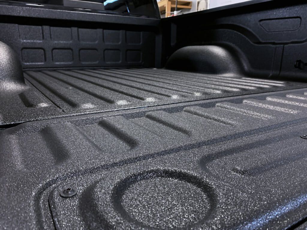 Black textured truck bed with protective coating.